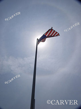  Crystalline Halo
Ice crystals high in the sky form complete halo around the sun.
The American flag and pole are curved from the effects of the wide angle lens.
Keywords: halo; ice; sun; flag; circle; arc; twilight; Beverly; art; photograph; picture; print; beverly